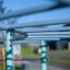 Outdoor play equipment, Dolphin steel structure, close-up of light blue horizontal bars.