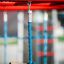 Dolphin steel structure with blue rope and wooden bar in playground.