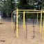 Yellow Dolphin steel structure playground equipment in a park setting