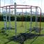 Outdoor playground equipment 'Dolphin steel structure' with climbing ropes and bars beside marina.