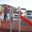 Children playing on the Junior single slide with climbing structure.