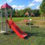 Ladybird playhouse with slide in a park.