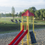 Ladybird playhouse with slide in a park