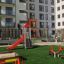 Ladybird playhouse with slide in residential playground