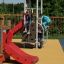 Children playing on Ladybird playhouse with slide.