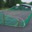 Outdoor sports court 'San Siro' with fencing and basketball hoop.