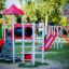 Playground with Beetle playhouse with slide and steel structure.
