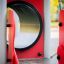 Beetle playhouse with slide, steel structure, close-up of tunnel and surrounding red panels