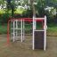 Orca steel structure climbing ropes and wall in a playground with trees in the background