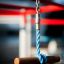 Close-up of the Orca steel structure playground equipment with blue rope and red bars.
