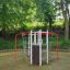 Orca steel structure playground equipment surrounded by greenery