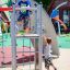 Children playing on an Orca steel structure playground.