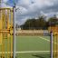 Maracana playground with yellow metal fencing and open center court.