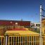 Maracana playground with yellow and red sports area and basketball hoop.