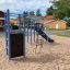 Playground equipment with Whale steel structure featuring climbing wall and slide.