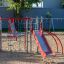 Whale steel structure playground equipment with slides and climbing frames in a sand playground.