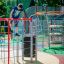 Child playing on Whale steel structure in a colorful playground.