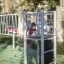 Child playing on Sword fish steel structure climbing frame in playground.