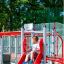 Child playing on the Sword fish steel structure slide in a playground.