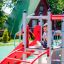 Child playing on the Sword fish steel structure at a playground.
