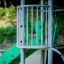 Butterfly steel structure in a playground with green and grey elements
