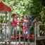 Children playing on Spider steel structure playground equipment outside.