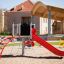 Steel structure of Crow's Nest playground equipment with slide and climbing net.