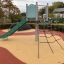 Crow's Nest steel structure with slide and climbing net in a playground.