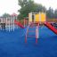 Crow's Nest steel structure playground equipment with slides and climbing features on blue rubber su