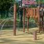 Wooden playground climbing structure Alv with rope net and slide in a park.