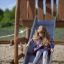 Child sliding down Alv playground slide.