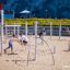 Children playing on Alv playground equipment with climbing ropes and poles in a sandy play area.