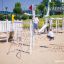 Children playing on Alv playground equipment in a park.