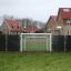Football goal with black panels installed in a residential area.