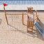 Nature Ship Sandbox, wooden playhouse with slide and climbing net on sandy playground.