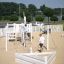 Nature Ship Sandbox, wooden playhouse in a sunny playground with children playing