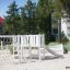 Wooden playground with a Nature Ship Sandbox and a slide.