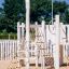 Nature Ship Sandbox, wooden playhouse with climbing ropes and a red flag.