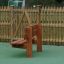 Larchwood Bench in a park with a wooden fence in the background