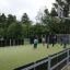 Children playing soccer on Stamford Bridge multifunctional sports court with basketball hoops.