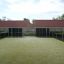 Mini sports field with artificial turf named Stamford Bridge, located between residential houses.