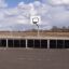 Outdoor sports barrier with a basketball hoop by Stamford Bridge.