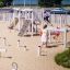 Children playing on the Alstad outdoor playground equipment.