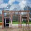 Children's playground equipment from Alstad in a residential area with climbing frames and ladder.