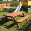 Larchwood Table & Bench in a playground with slide in background