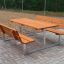 Outdoor Table & Bench set with wooden seats and a metal frame on a paved surface.