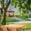 Wooden Table & Bench set under a tree in a park.