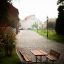 Table & Bench outdoor seating on a cobblestone path in a serene town setting