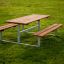 Wooden outdoor Table & Bench on a grassy field.