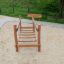 Dolomiti wooden playground balance bridge over sand with benches in background